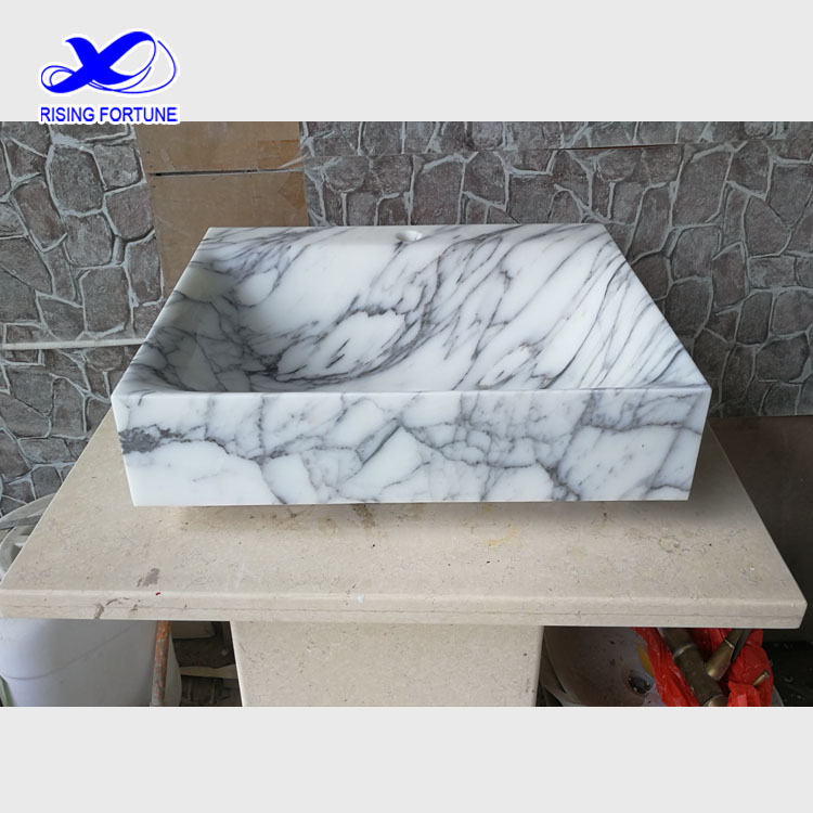 white marble vessel sink