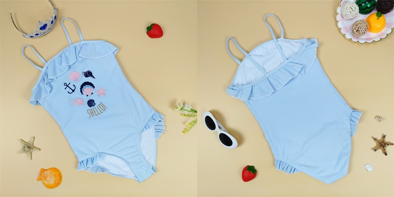 Girls one piece beachwear with ruffles around neckline and leg opening Girls one piece beachwear with ruffles around neckline and leg opening